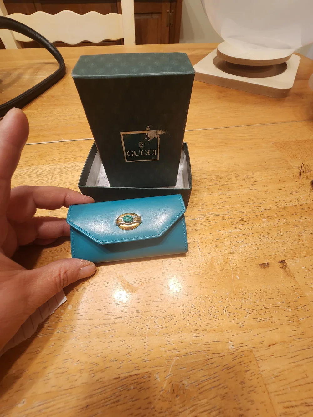 vintage Gucci teal leather key case featuring a distinctive cabochon stone